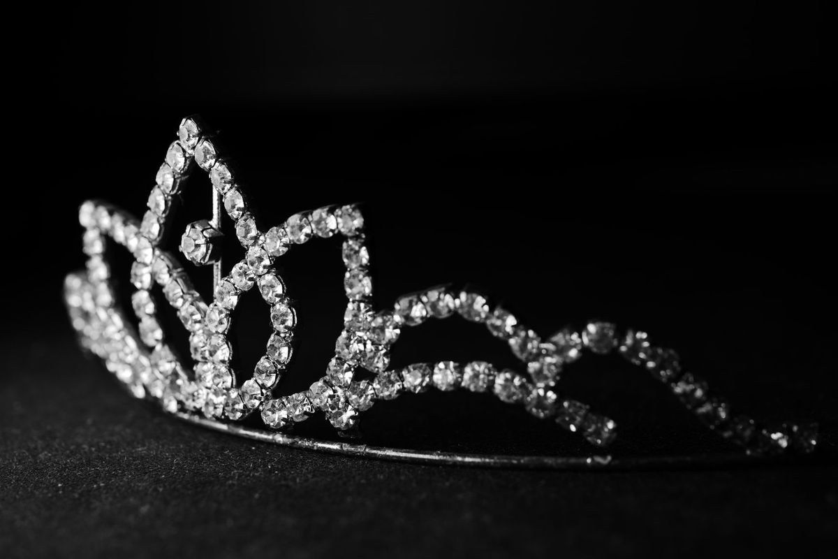 A diamond tiara sparkling against a black background.