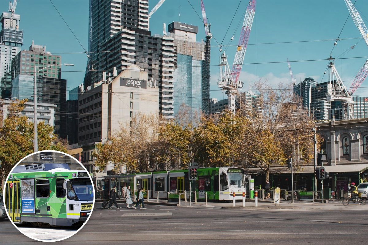 Melbourne trams travelling through the city centre with the CBD skyline behind.