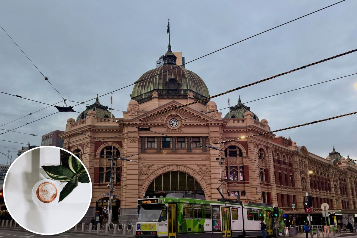 Flinders Street Station in Melbourne with a green-and-yellow tram passing in front.