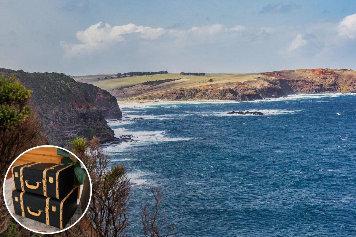 Illustrative coastal stock photograph of cliffs and blue water with a suitcase inset; not the MotoGP circuit.
