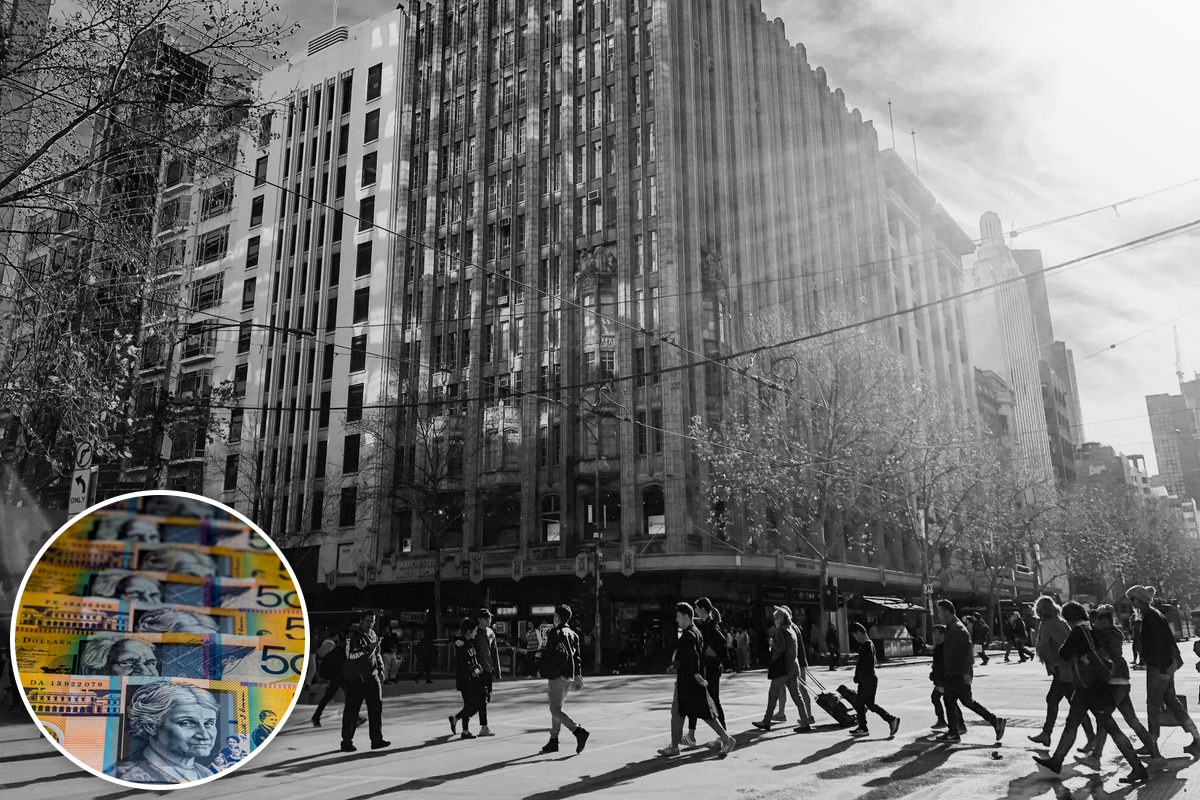 A black and white photograph of pedestrians crossing a street in the Melbourne CBD beneath tall buildings.